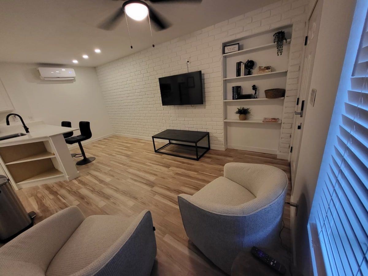 Furnished McFadden Pad living area with seating and a kitchen bar
