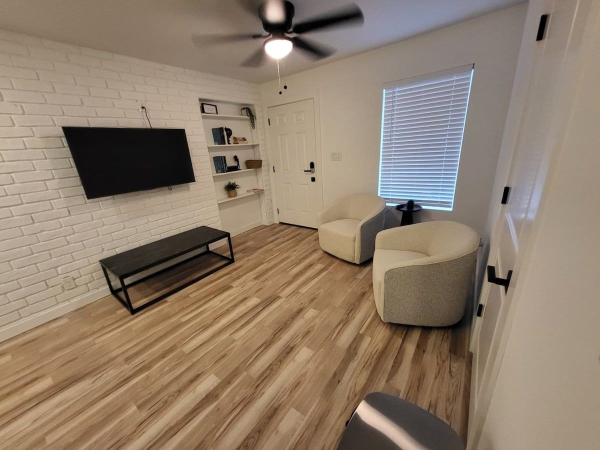 Furnished McFadden Pad living room with sofa and lounge chair